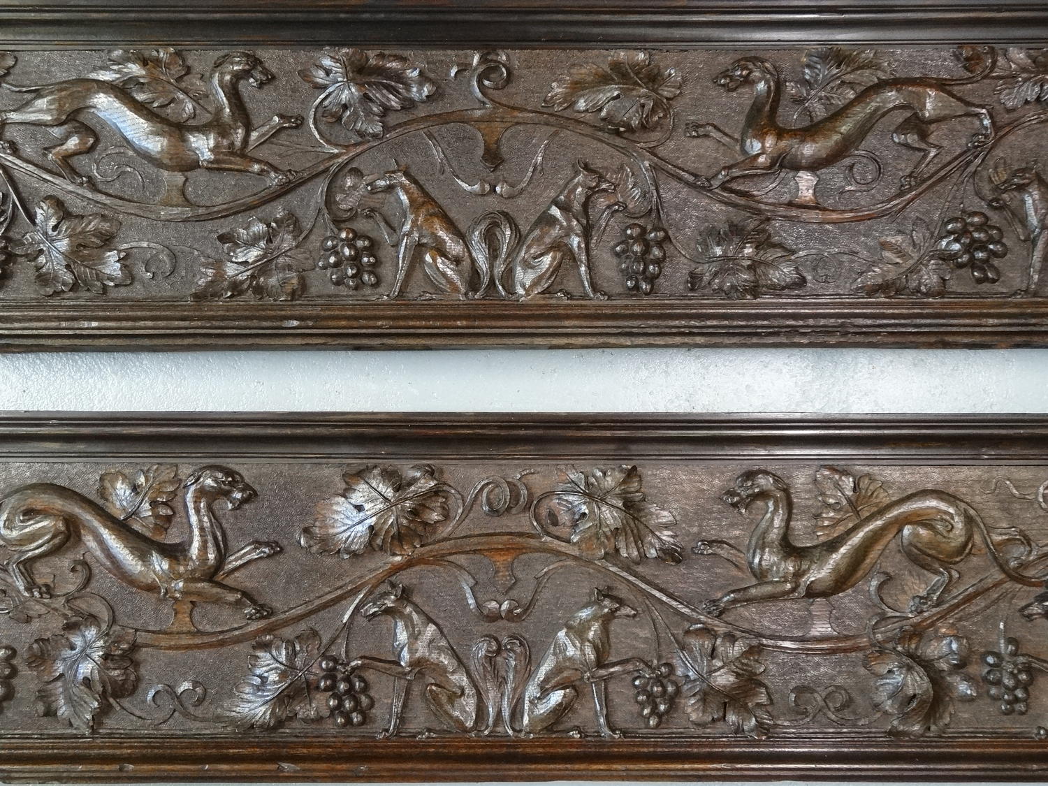 Pair of richly carved animal dog panels