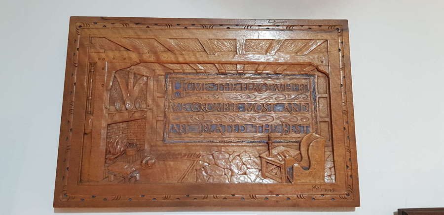 Arts & Crafts interior scene fireside setting carved panel with motto