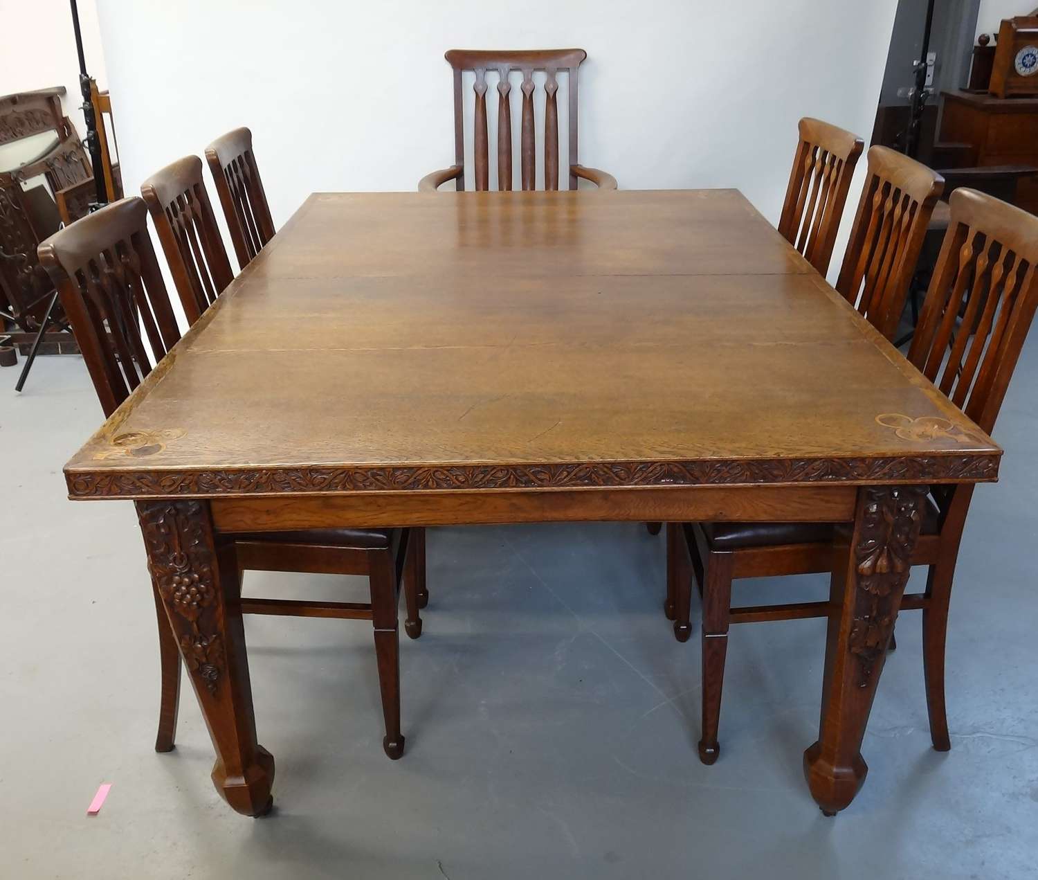 Rare Arthur Simpson of Kendal inlaid carved dining table and chairs